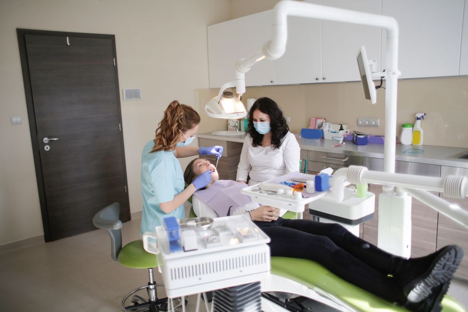 Female dentist performs treatment on a patient in a modern dental clinic. 10
